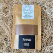 Pouch of pumpkin spice seasoning sitting in a basket of raffia.